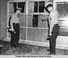 Police_examine_broken_window_of_home_belonging_to_first_black_family_to_move_to_Levittown